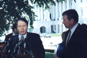 Steve gives a talk with congressman looking on